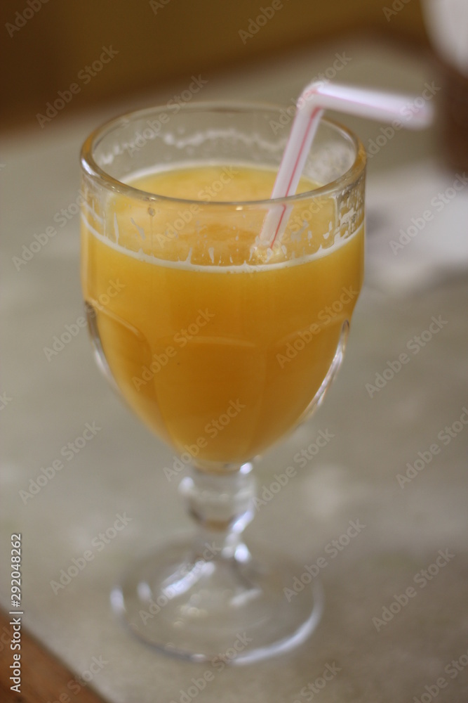 Glass of orange juice on wooden table Glass of orange juice on wooden table