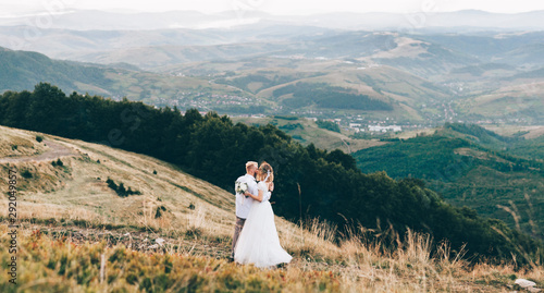 Beautiful wedding couple  bride and groom  in love on the background of mountains. Wedding in mountains . Beauty of carpathian mountains  Ukraine