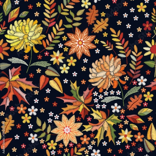 Embroidered seamless pattern on autumn theme. Trendy print with cute embroidery of flowers and leaves.