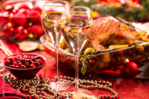 Christmas themed dinner table with christmas duck and champagner 