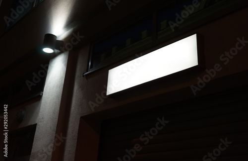 Empty white luminous information panel.  Dark night.