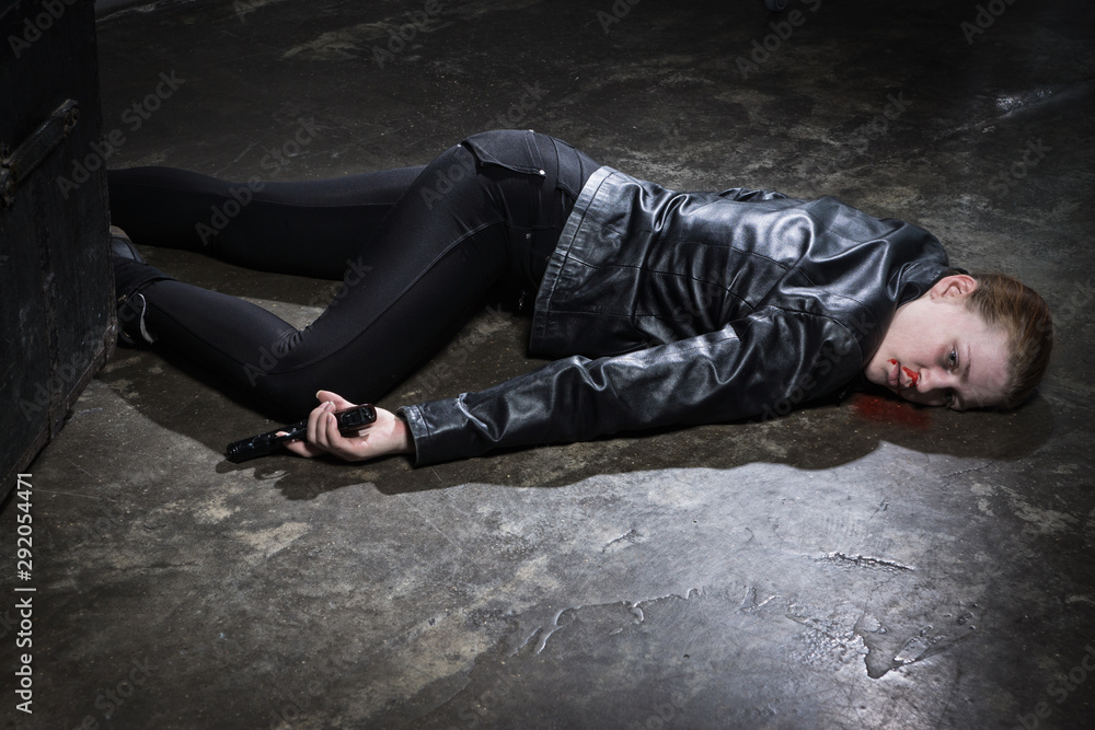 Crime scene imitation. Dead woman lying on a floor.. Stock Photo