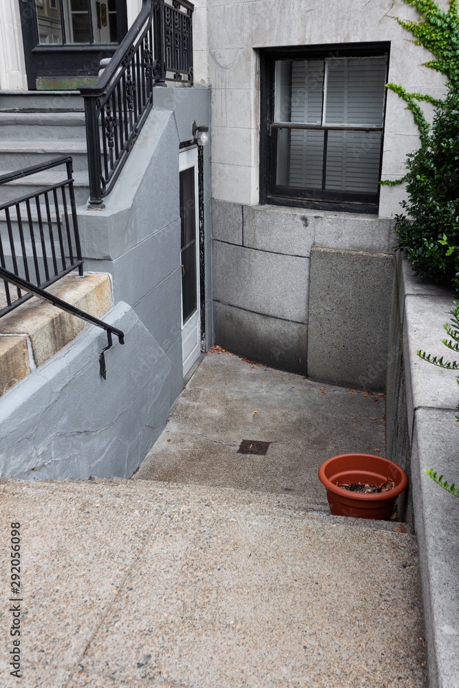 Old brownstone apartment building with upper and lower entryways, horizontal aspect Old brownstone apartment building with upper and lower entryways, horizontal aspect