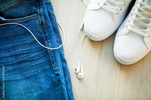 Jeans and white sneakers on the store shelf.