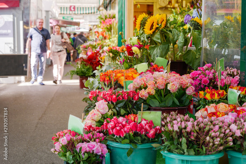 View of colourful various flowers in plastic box are sold at corridor in front of flower stall or floral shop is located in outdoor market in Europe. Typical atmosphere of flower store.    © Peeradontax