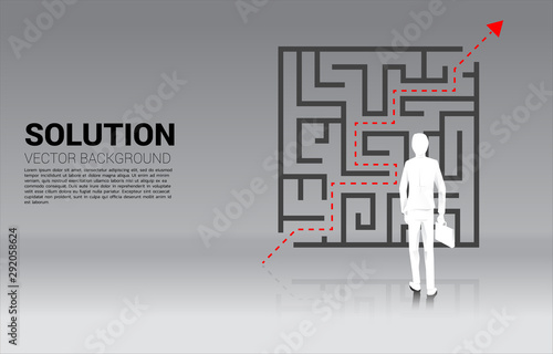 Silhouette of Businessman standing with plan to exit from maze . Business concept for problem solving and solution strategy. 