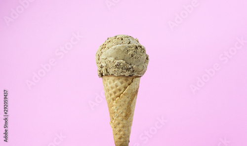  ice cream mocha scoop in waffle cone on pink background, Closeup Front view Food concept.