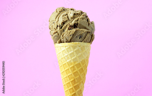 Ice cream mocha scoop in waffle cone on pink background, Closeup Front view Food concept..