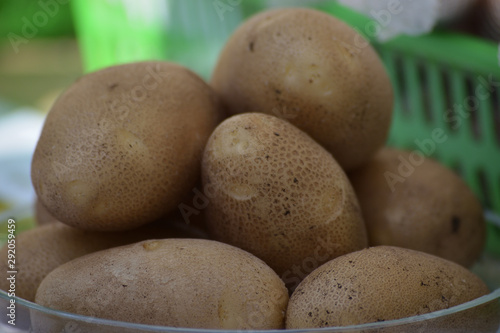 Potato tubers close-up on a glass plate