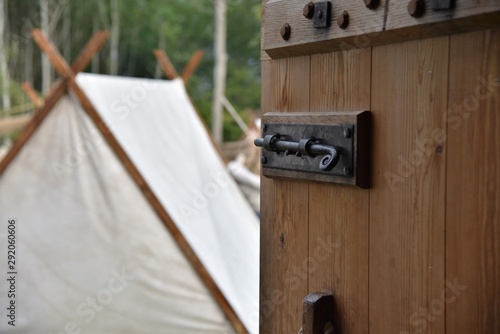 Photos Historic wooden church door opens to ancient viking village made of white tents