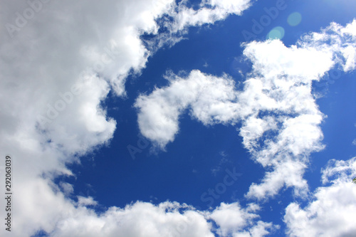 Blue sky with white clouds. Clouds in the form of a spiral, a natural frame of clouds.