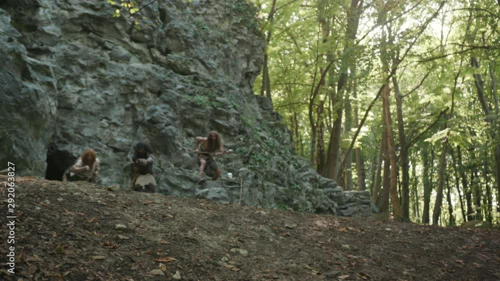 Primeval cave people of hunter-gatherers tribe get out of cave run fast pursuing animals for prey hunting in forest jungle mountain pristine nature. Primeval cave people of hunter-gatherers tribe get out of cave run fast pursuing animals for prey hunting in forest jungle mountain pristine nature.