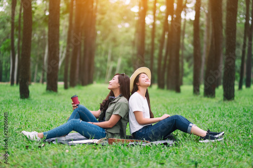 Two women sitting in the woods with feeling relaxed