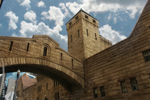 Brick Stone building with bridge windows Cloudy sky