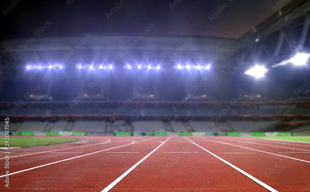 Running track in a stadium under bright spotlights