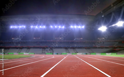 Running track in a stadium under bright spotlights