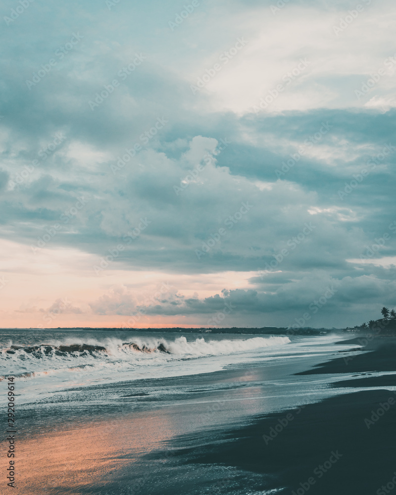 Fototapeta premium Wallpaper- Ocean sunset on black sand beach