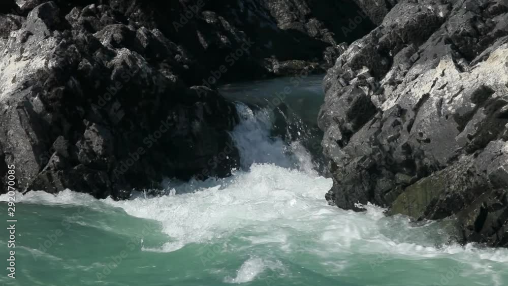 A small cascade of a waterfall on a mountain river. Turquoise water. A small cascade of a waterfall on a mountain river. Turquoise water.