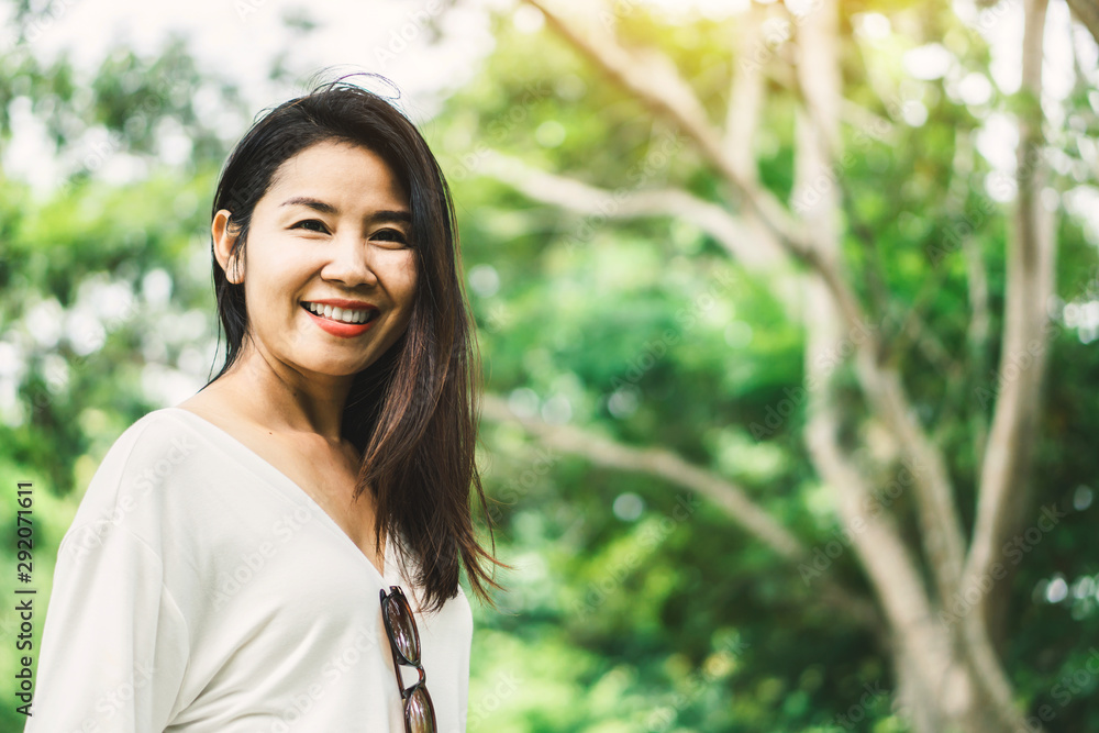 portrait of beautiful Asian woman smiling outdoors with nature background portrait of beautiful Asian woman smiling outdoors with nature background