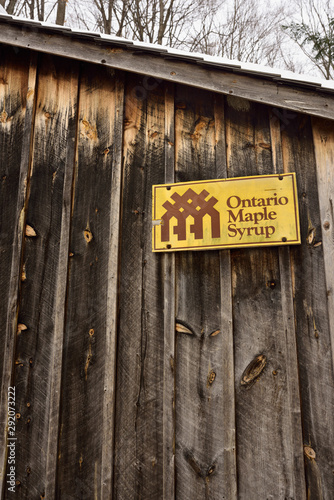 Wood sugar shack with the Ontario Maple Syrup Producers Association sign