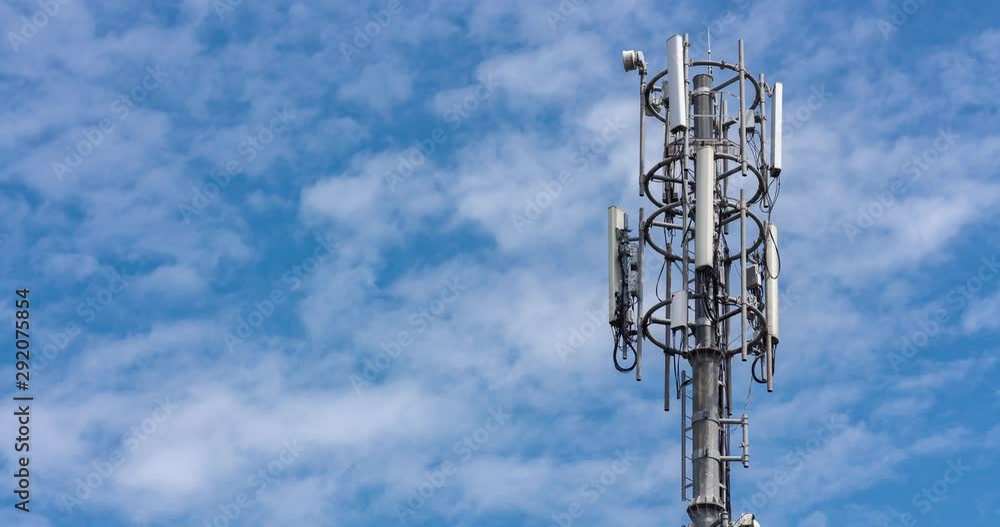 Cell tower on blue sky background. Floating clouds in blue sky, time lapse. Cell tower on blue sky background. Floating clouds in blue sky, time lapse.
