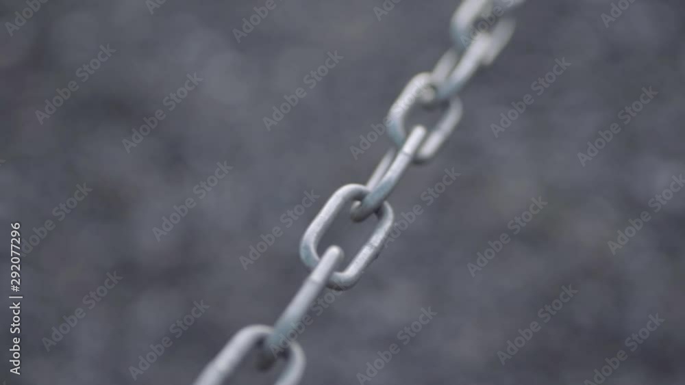 Isolated strong metal chain sways in breeze Isolated strong metal chain sways in breeze