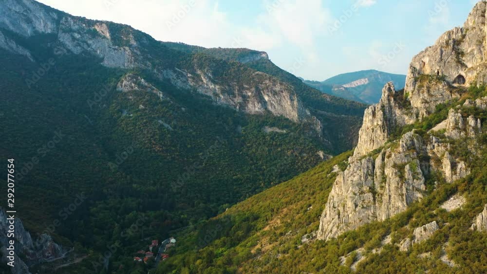 Cinematic aerial pan mountain rocky peaks in distance, autumn forest Cinematic aerial pan mountain rocky peaks in distance, autumn forest