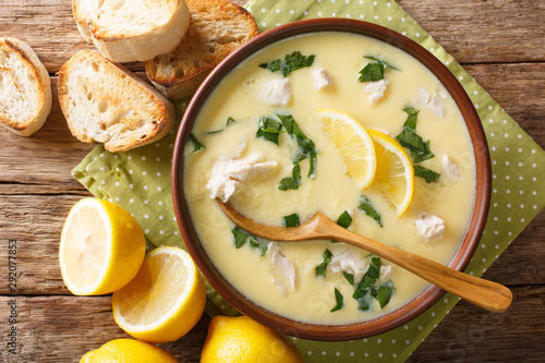 Thick aromatic Greek lemon soup with chicken and orzo paste close-up in a bowl. Horizontal top view photo