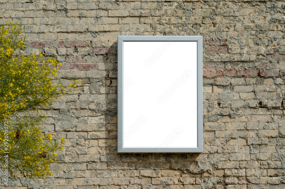 Blank white mock up template of poster with steel frame on old brick wall. Background texture for information/advertisement board. Blank white mock up template of poster with steel frame on old brick wall. Background texture for information/advertisement board.