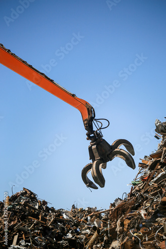 Industrial claw machine, move scrap metal in the landfill. Excavator arm, claw crane.