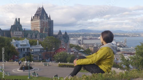 Canada travel Quebec city tourist enjoying view of Chateau Frontenac castle and St. Lawrence river in background. Autumn traveling holiday people lifestyle. photo