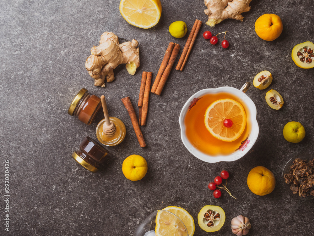 green tea with lemon,red berries, different honey,ginger, propolis, cinnamon sticks, cydonia, Warm drink beverage infusion in white cup for cold flu winter fall days green tea with lemon,red berries, different honey,ginger, propolis, cinnamon sticks, cydonia, Warm drink beverage infusion in white cup for cold flu winter fall days