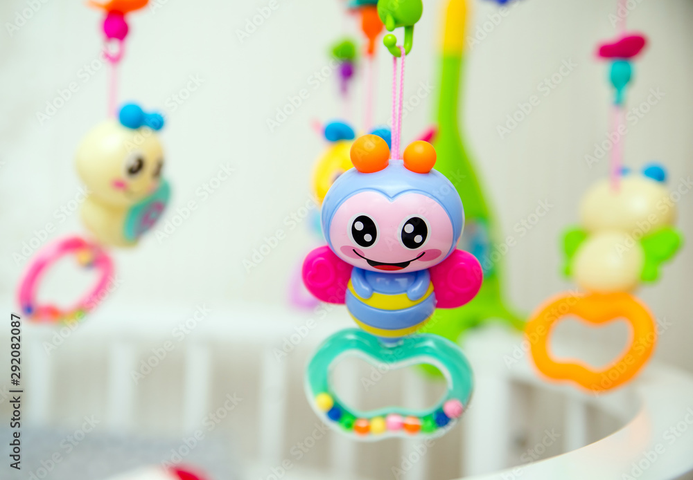 Fototapeta premium Children's toys hanging over the baby's crib