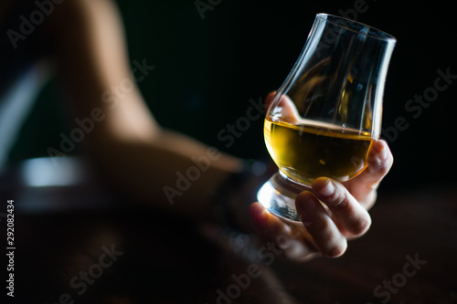 Hand holding a Glencairn whisky glass