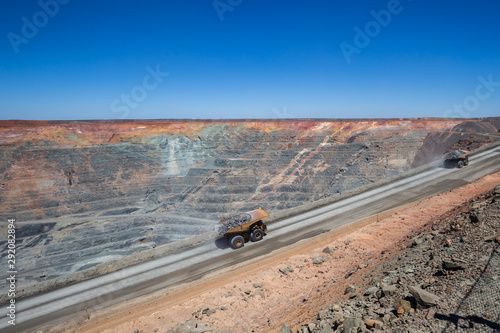 Loaded haulpaks climbing out of the Kalgoorlie Super Pit, one of the largest gold mines in the World. Gold was discovered in Kalggorlie in 1892. photo