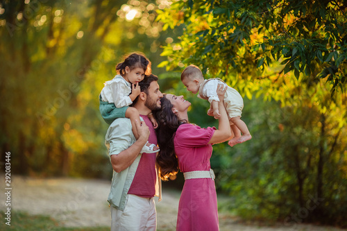 Happy family: mother, father, children son and daughter on nature have a fun on summer day