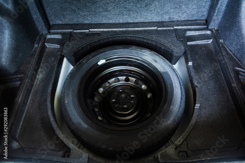 spare rubber tire in the trunk of a modern car