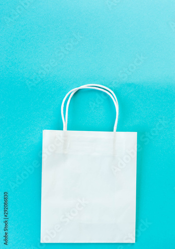 white Kraft package on bright turquoise background