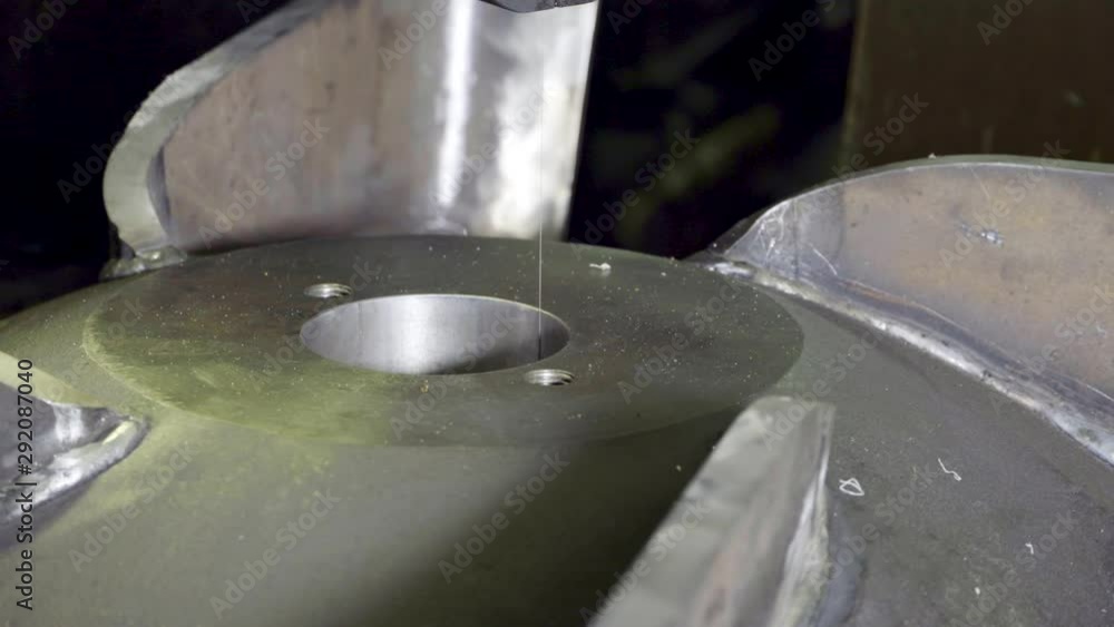 Steel thread for metal cutting, cuts a slot in a large workpiece. Industrial machine tools indoors. Steel thread for metal cutting, cuts a slot in a large workpiece. Industrial machine tools indoors.