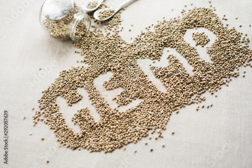 Word HEMP made of hemp seeds on linen background. Healthy eating supplement. Superfood concept. Top view.