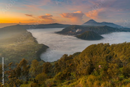 Beautiful view of Mount Bromo volcano during sunrise with white mist at Bromo tengger semeru national park, East Java, Indonesia © Sugrit