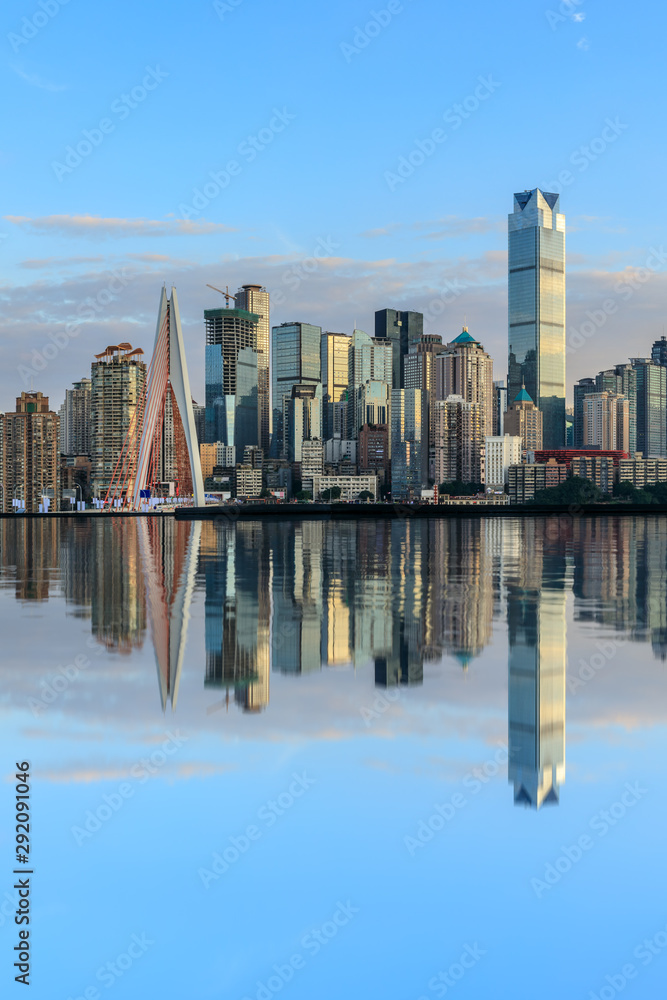 Fototapeta premium Chongqing skyline and modern urban skyscrapers with water reflection at sunset,China.