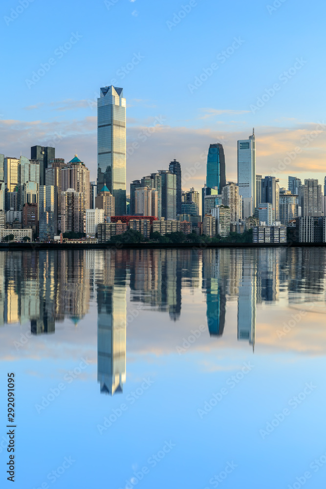 Chongqing skyline and modern urban skyscrapers with water reflection at sunset,China.