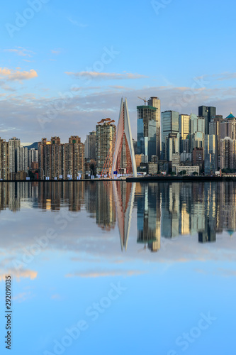 Chongqing skyline and modern urban skyscrapers with water reflection at sunset,China.