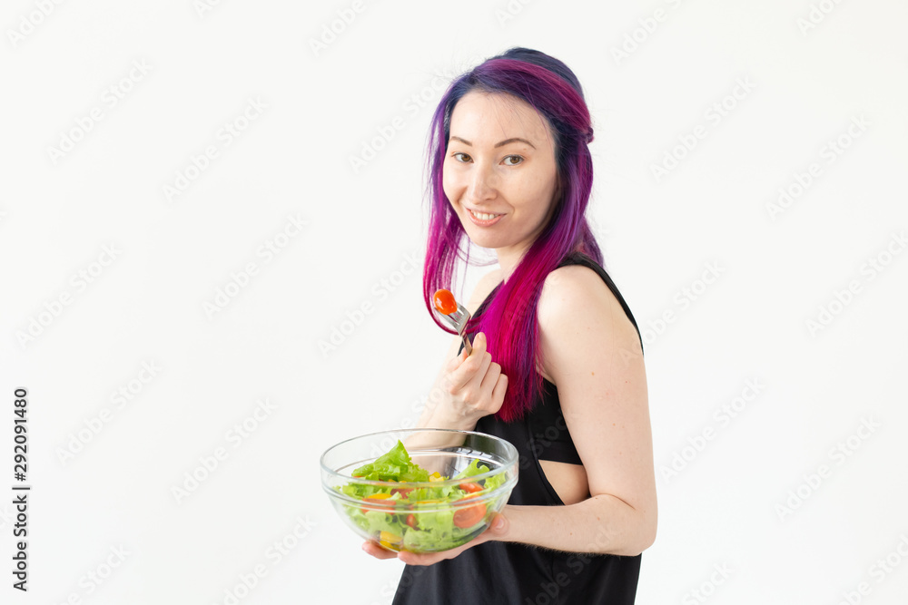 Young asian fitness girl with colored hair holding in hands vegetable salad. Healthy eating concept. Young asian fitness girl with colored hair holding in hands vegetable salad. Healthy eating concept.