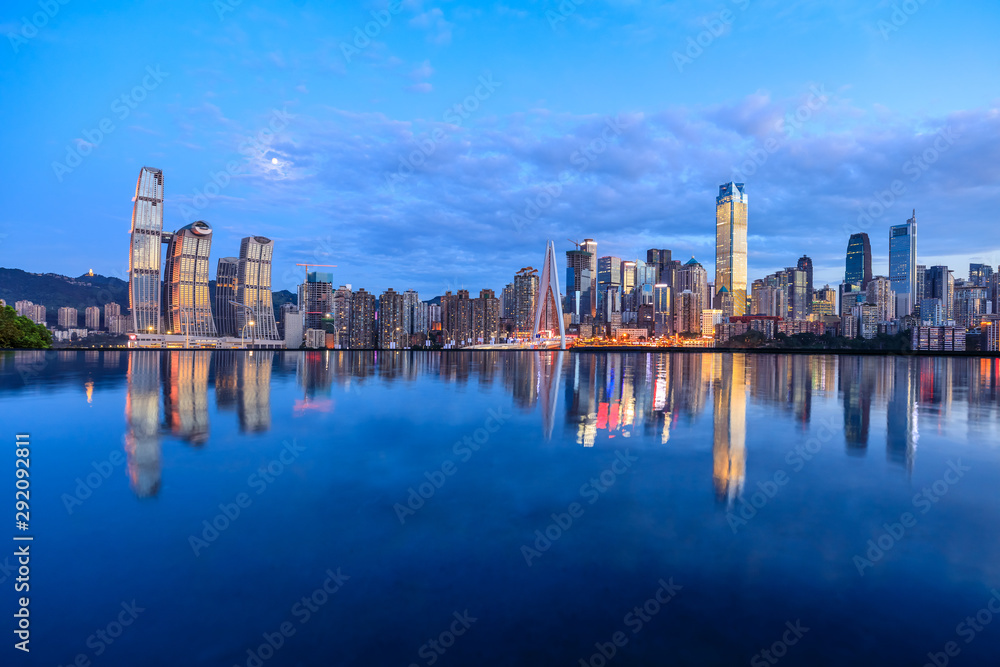Chongqing skyline and modern urban skyscrapers with water reflection at night,China.