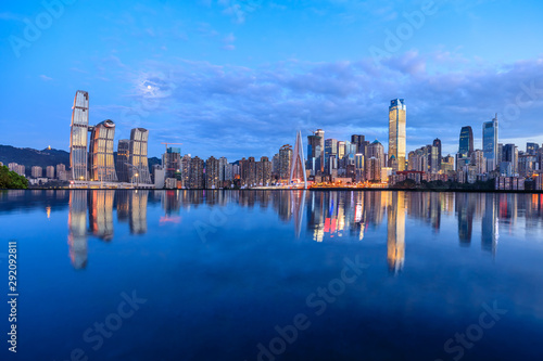 Chongqing skyline and modern urban skyscrapers with water reflection at night,China.