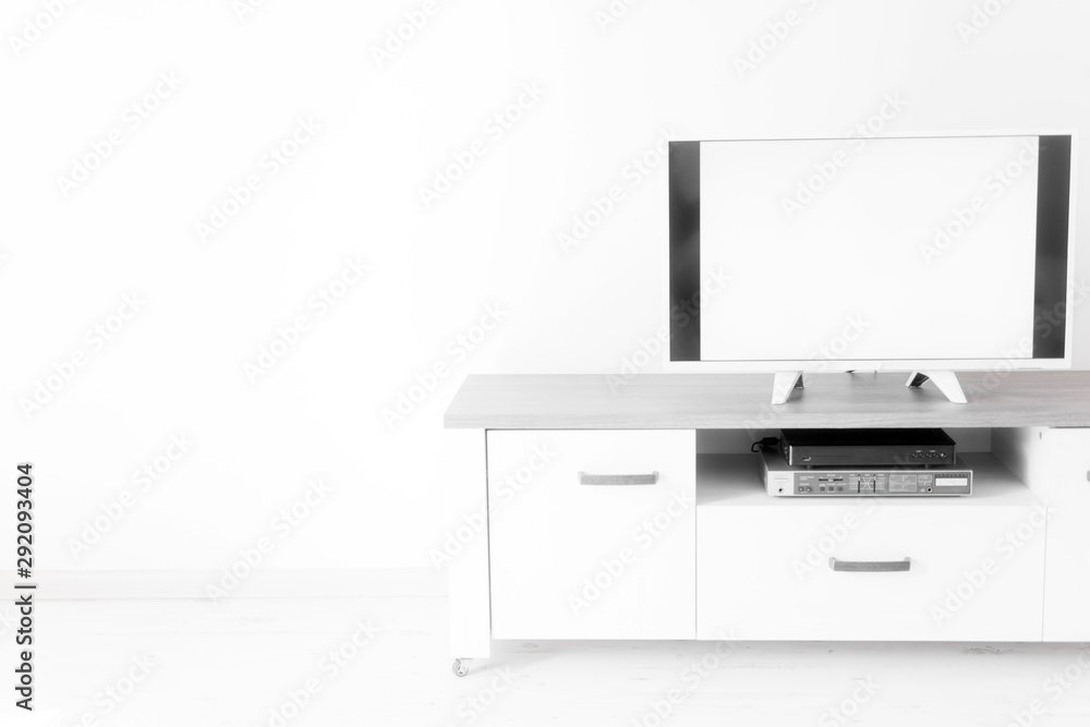 TV with white screen on a stand in the room. TV with white screen on a stand in the room.