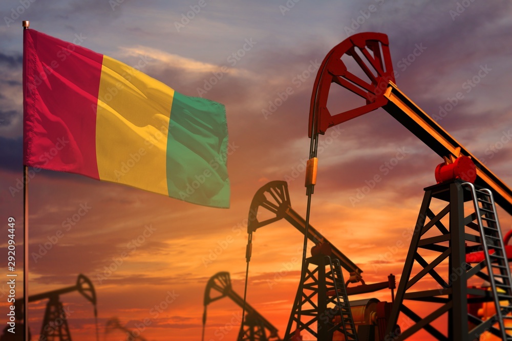 Guinea oil industry concept. Industrial illustration - Guinea flag and oil wells with the red and blue sunset or sunrise sky background - 3D illustration