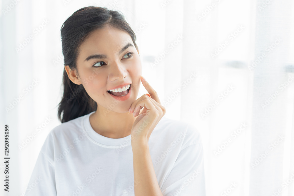 Closeup young woman smiling face with clean skin in room - Closeup young woman smiling face with clean skin in room -